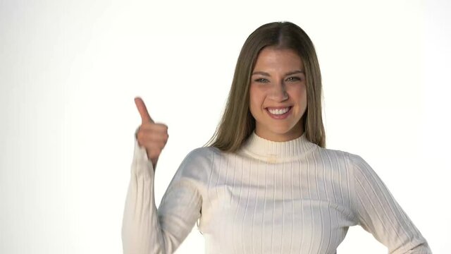 young beautiful woman with makeup, begins to laugh and showing thumbs up on white background
