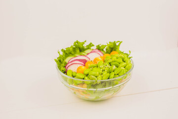 a glass bowl with vegan food on the white background