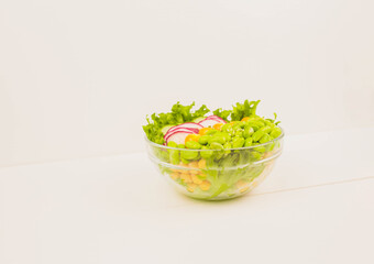a glass bowl with vegan food on the white background