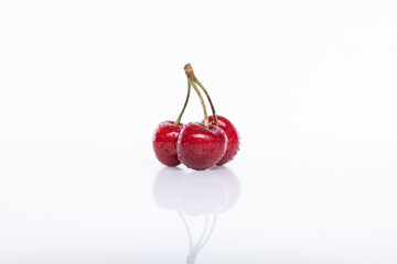 red raw fresh cherries on white background, close view 