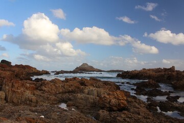 Beautiful seaside with rocks under cloudy sky