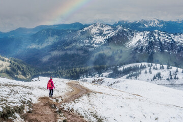 Fototapeta premium active woman hiking in the first autumnal snow in the Allgau Alps near Oberstaufen, Bavaria, Germany 