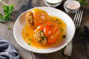 Stuffed peppers with ground meat and rice in tomato sauce