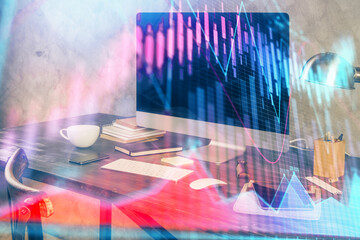Financial graph colorful drawing and table with computer on background. Double exposure. Concept of international markets.