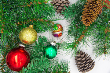 Obraz na płótnie Canvas New Year's toys, fir-tree branches, cones on a white background. New Year holiday concept.
