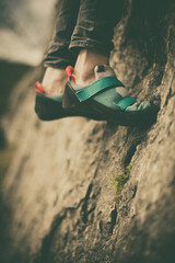 Person climbing while wearing rock climbing shoes