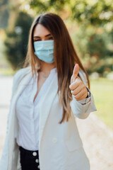 Wearing a protective mask is great. The businesswoman is happy while wearing the facemask. Prevention of coronavirus. 