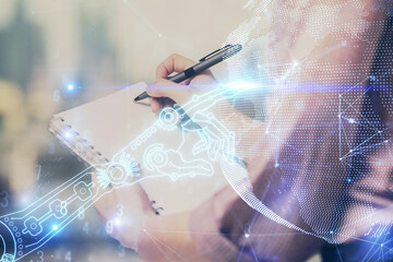 Technology theme hologram over woman's hands taking notes background. Concept of Tech. Double exposure