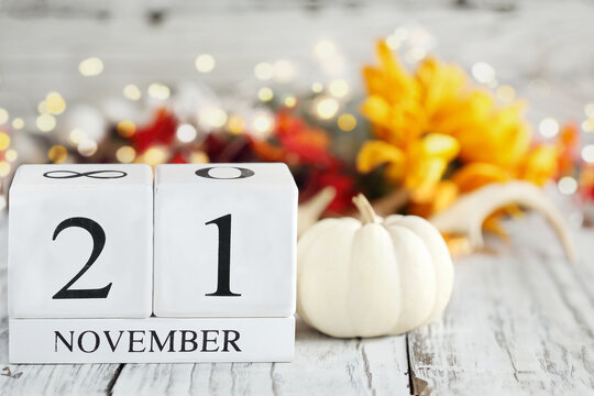 International Survivors of Suicide Day. White wood calendar blocks with the date November 21st and autumn decorations over a wooden table. Selective focus with blurred background. 