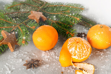 Fototapeta na wymiar Christmas decoration card with fir branch, peeled mandarins or tangerines, anise
