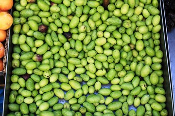 Stall with green olives at street market in Athens, Greece.