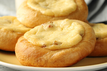 Cheesecakes with cottage cheese and raisins, round buns (Vatrushka). Homemade baked goods, close-up.