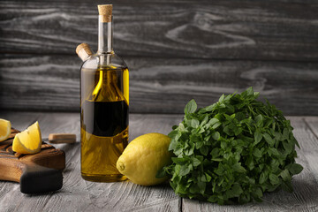 Lemon, balsamic vinegar, olive oil and green basil are ingredients for making a simple and tasty dressing for many salads.