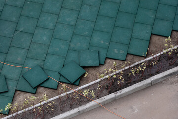 Installation of elastic EPDM synthetic rubber pavement on existent asphalt surface as playground...