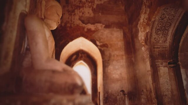 statue of sitting Buddha inside an untitled simple temple in Bagan Myanmar