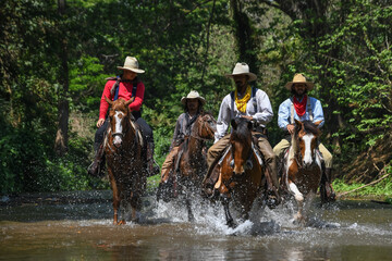 Four young cowboys and horses Was traveling across the river
