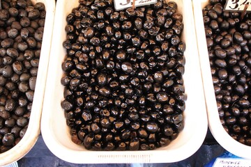 Stall with Throubes olives from Amfissa at street market in Athens, Greece.