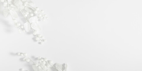 Christmas holiday composition. Xmas white decorations. White fir tree branches and berry on white background. Christmas, New Year, winter concept. Flat lay, top view, copy space