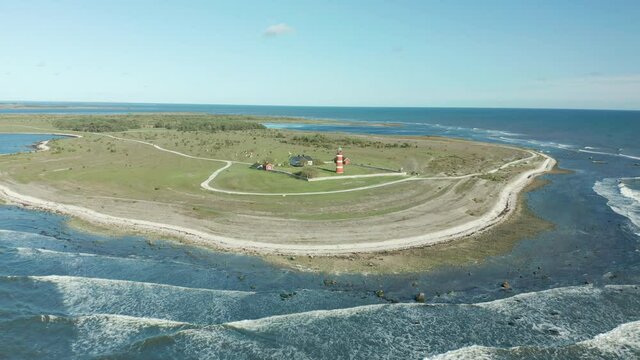 Beauitful lighthouse, aerial footage flying over sea in bautiful coastal area toward tower