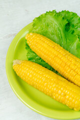 Corn on the cob on a green plate