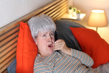 Senior woman gossiping through mobile phone
