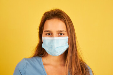 beautiful young woman wearing face mask to prevent coronavirus infection