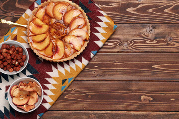 Top view of apple tart pie on tablecloth