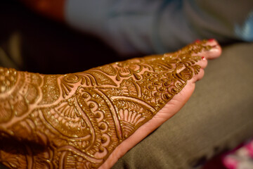 Henna is applied to the legs of a beautiful  Hindu Bride on her wedding.