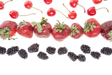red raw fresh strawberries and cherries with blackberries on white background, close view 