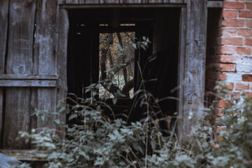 Fototapeta na wymiar looking through old abandoned barn. Doors and windows.