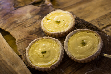 delicious portuguese egg tart on wood background.
