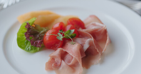 Appetizer parma ham on dish