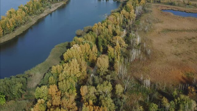Aerial Flying over countryside, many lakes of fish farm, far big river under amazing cloudy sky in autumn time. Wonderful drone photo for ecological concept