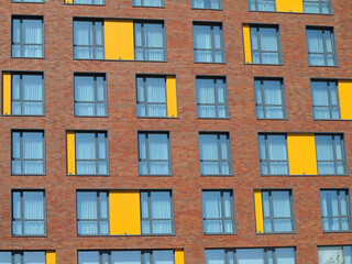 Abstract brown and yellow brick facade with windows