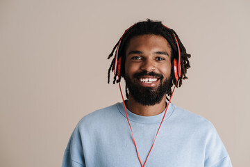 Cheerful african american guy in headphones smiling at camera © Drobot Dean
