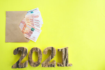
On a yellow background, an envelope with money, Russian five-thousandth rubles. Figures...