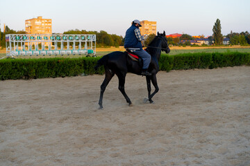 Man riding a horse at the racetrack