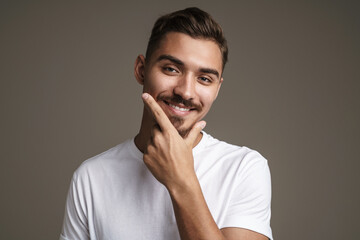 Image of joyful unshaven guy laughing while posing on camera