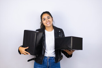 Obraz premium Young beautiful woman holding gifts over isolated smiling and looking at the camera white background