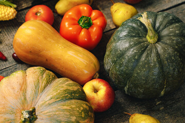 Beautiful composition with autumn vegetables on weathered wooden background