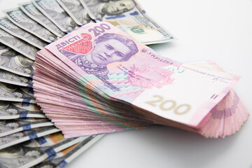 collection of hundred-dollar and two hundred hryvnia banknotes isolated on white background, close view