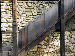 beautiful wooden stairs to an old stone housewhit