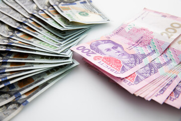 collection of hundred-dollar and two hundred hryvnia banknotes isolated on white background, close view