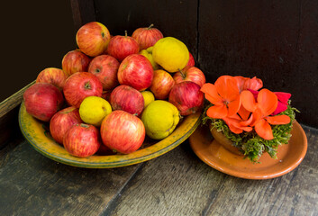 colorful homemade apples and flowers on the window of a country house