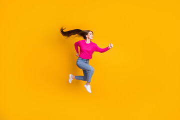 Fototapeta na wymiar Full length profile photo of lovely lady jump air long hairstyle wear pink pullover jeans sneakers isolated yellow color background