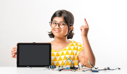 Electronic experiment - Indian girl student working with wires and connections inventing something