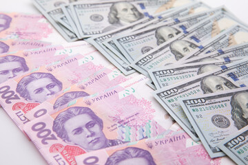 collection of hundred-dollar and two hundred hryvnia banknotes isolated on white background, close view