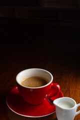 red cup of coffeewith milk on the table