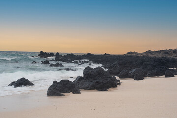 Beach with rocks surrounded by waves