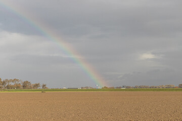 Rainbow in a flatland landscape in the autumn